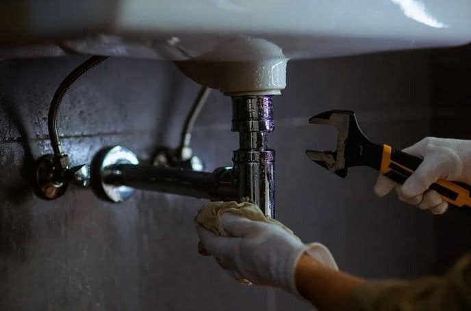 DIY plumbing fix under kitchen sink in Dubai apartment